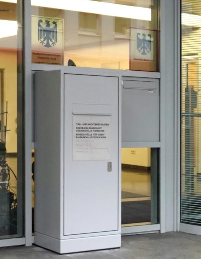 Tag- und Nachtbriefkasten auf einem Sockel montiert mit einem Hinweisschild mit der Aufschrift "Eisenbahn-Bundesamt Aussenstelle Hannover Bundesstelle für Eisen-Bahnunfalluntersuchung" vor der Tür des Bundesamtes